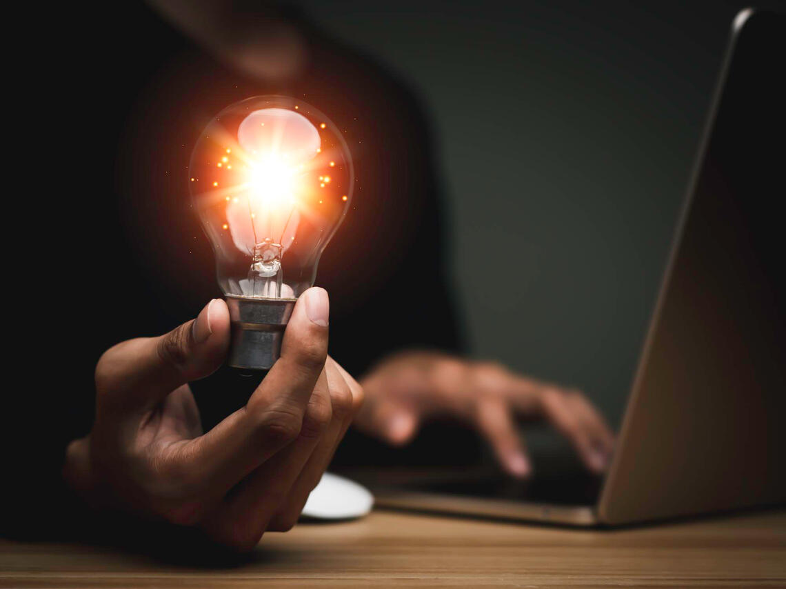 Business Idea business man holding lightbulb