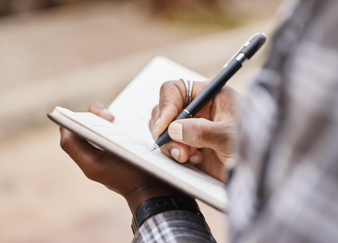 Writng in Notebook taking notes